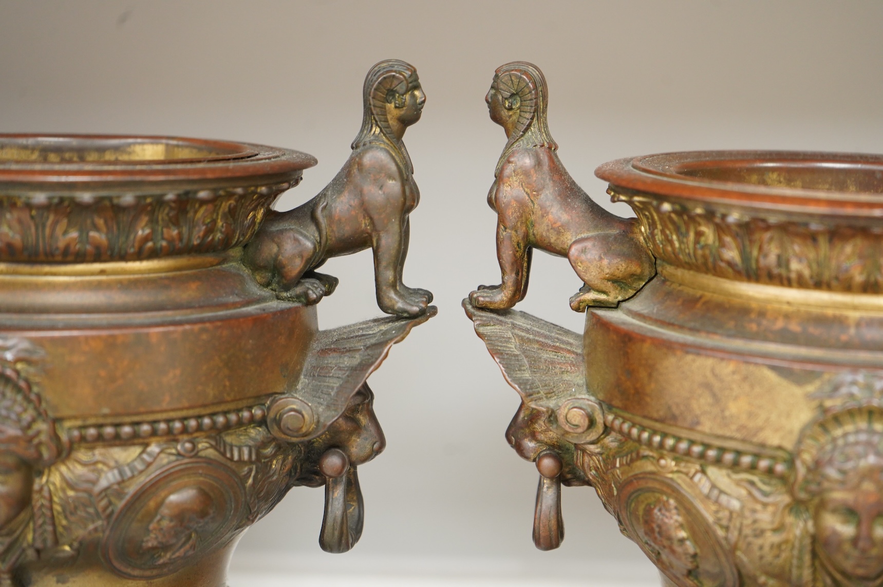 A pair of late 19 century French Egyptian revival bronze and rouge marble urns, 31cm high